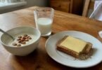 Calcium-rich breakfast of yogurt with almonds, a glass of milk and cheese on toast, for an article on calcium and weight loss