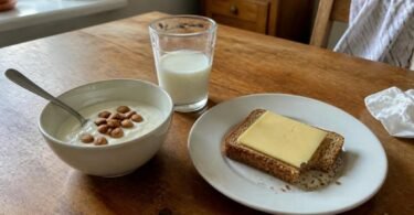 Calcium-rich breakfast of yogurt with almonds, a glass of milk and cheese on toast, for an article on calcium and weight loss