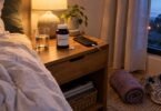 ZMA supplement (zinc, magnesium and vitamin B6) bottle and capsules on a bedside table with a glass of water at night